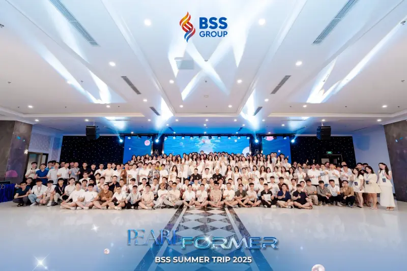 Hundreds of BSS team members posing together in a large hall for the BSS Summer Trip 2025 group photo