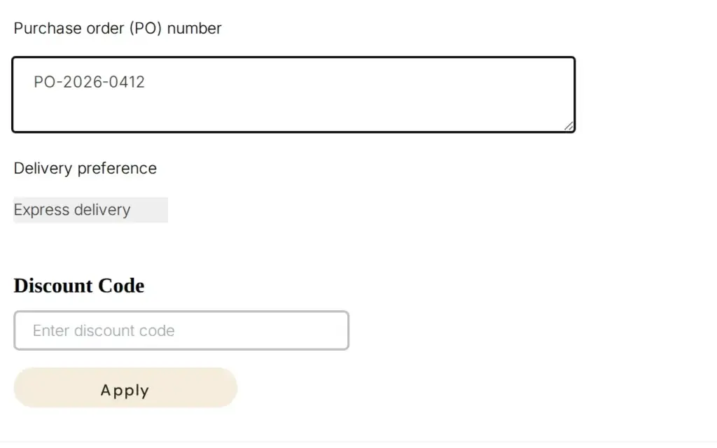 Demo storefront cart with a Purchase order (PO) number field filled with PO-2026-0412, a Delivery preference field and a Discount Code box